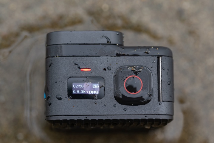 GoPro Hero 11 Mini'nin kum ve su ile üstten görünümü.
